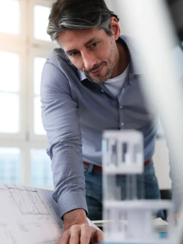 man-in-office-looking-at-architectural-model-2024-09-18-21-07-58-utc.webp